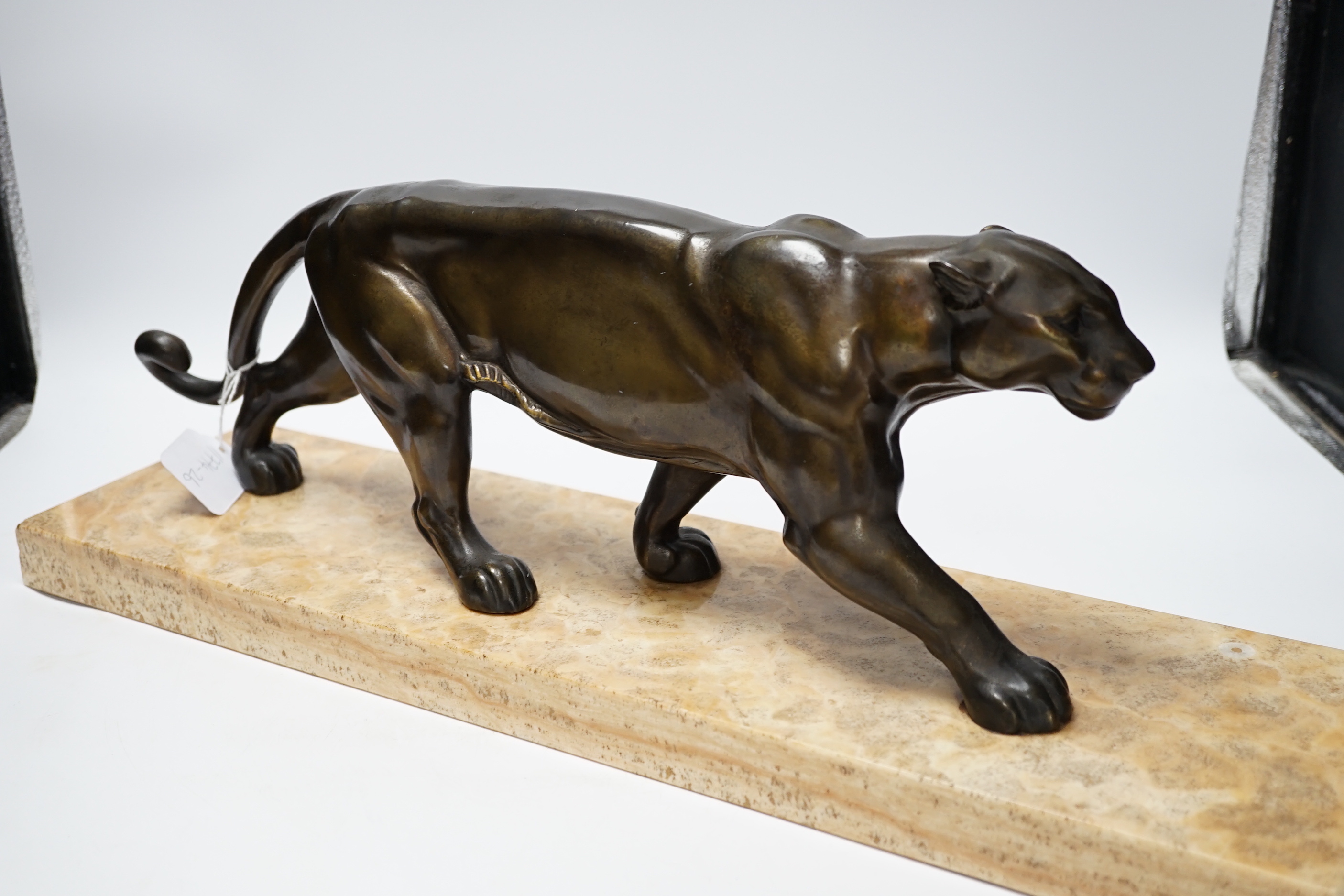 A French Art Deco bronzed metal model of a panther on a marble base, base 55cm wide